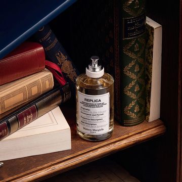 maison margiela replica perfume on bookshelf