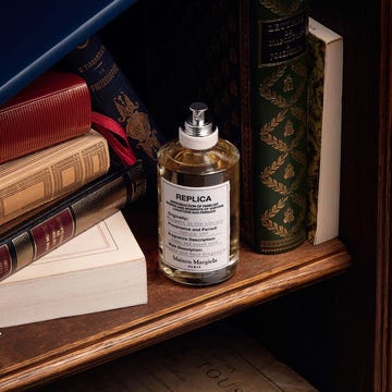 maison margiela replica perfume on bookshelf