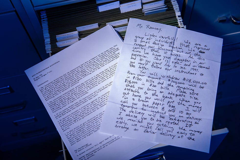a piece of paper with a handwritten note rests on an open file cabinet