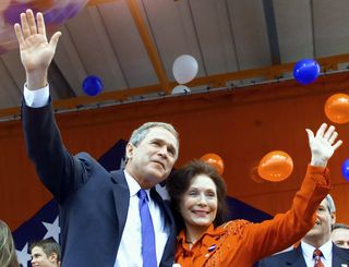 loretta lynn and george w bush wave to the crowd at a campaign rally in 2000