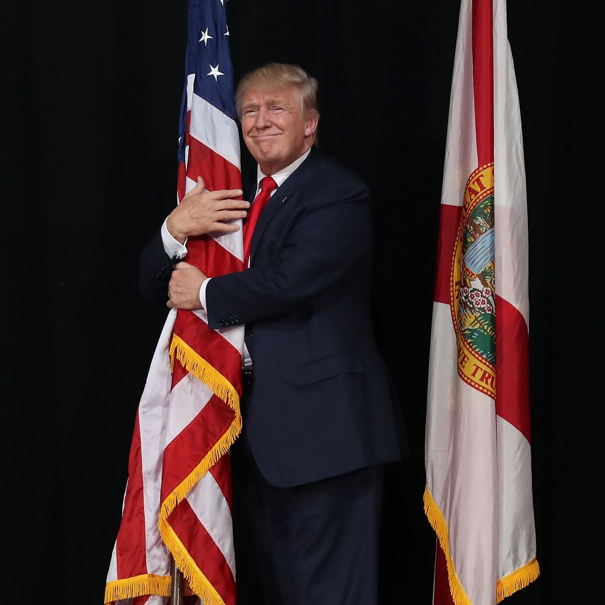 https://hips.hearstapps.com/hmg-prod/images/republican-presidential-candidate-donald-trump-hugs-the-news-photo-617806568-1560614003.jpg?crop=0.777xw:1.00xh;0.111xw,0&resize=1200:*