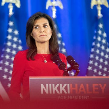 nikki haley standing at a podium with her name on it and looking out into the audience