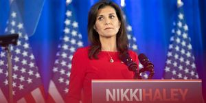 nikki haley standing at a podium with her name on it and looking out into the audience
