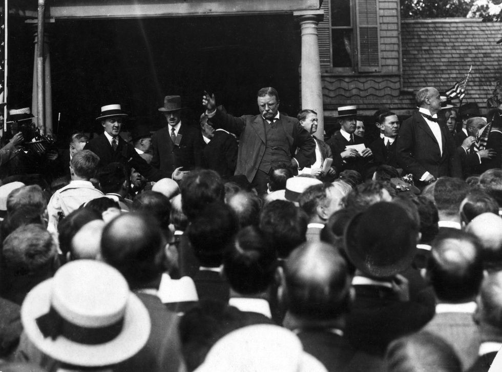 Theodore Roosevelt gestures to make a point as he addresses a crowd from the steps of Sagamore Hill