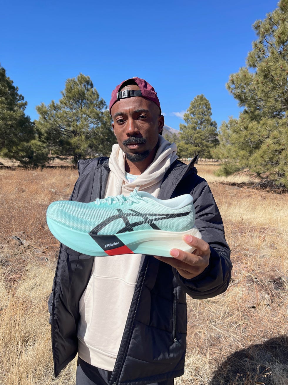 holding a running shoe outdoors