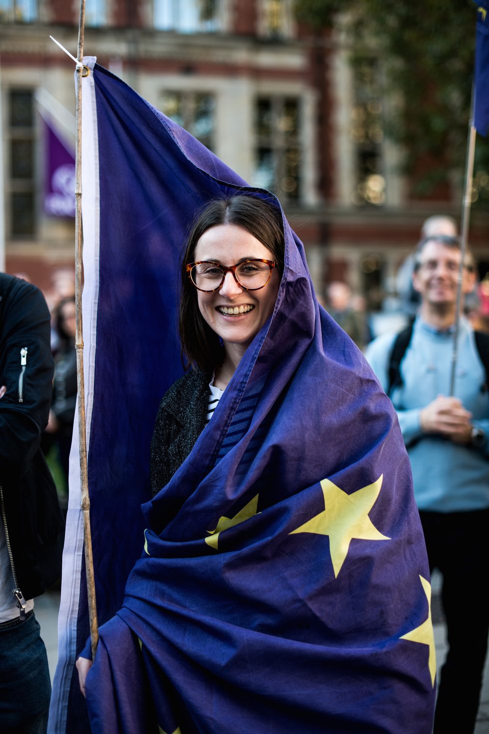 A women seen wrapped in a EU flag during the march.
 More