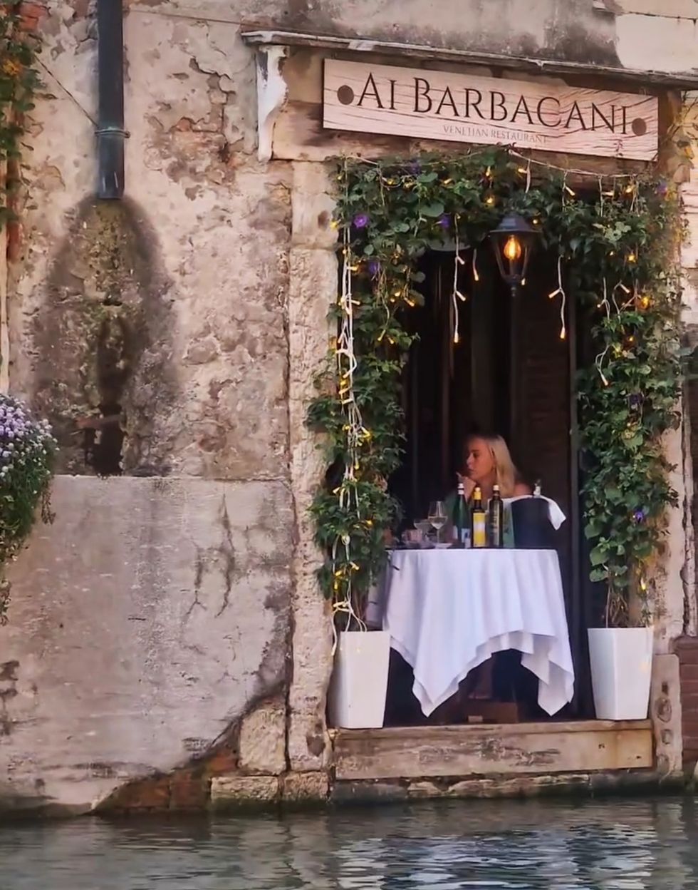 a person sitting at a tablet al barbican restaurant in venice