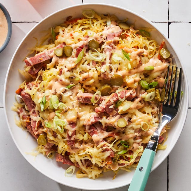 corned beef, cabbage, sauerkraut, cheese, and russian dressing in a bowl