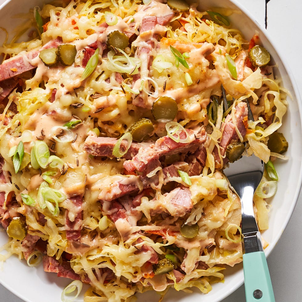corned beef, cabbage, sauerkraut, cheese, and russian dressing in a bowl