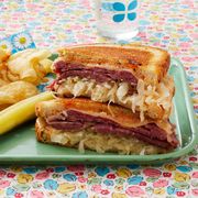 reuben sandwich with potato chips and pickles