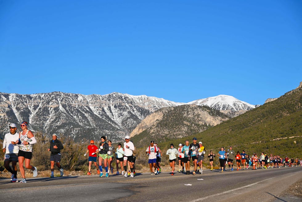 group of runners participating in a race on a scenic mountain road