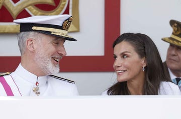 two individuals in formal attire engaged in conversation