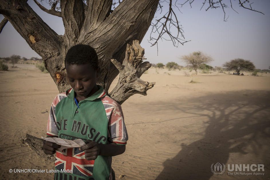 peter, an unaccompanied nigerian refugee, reads a letter he just wrote which explains his situation on february 11, 2015, at the dar es salam camp, near baga sola his dream is to go to school in ndjamena