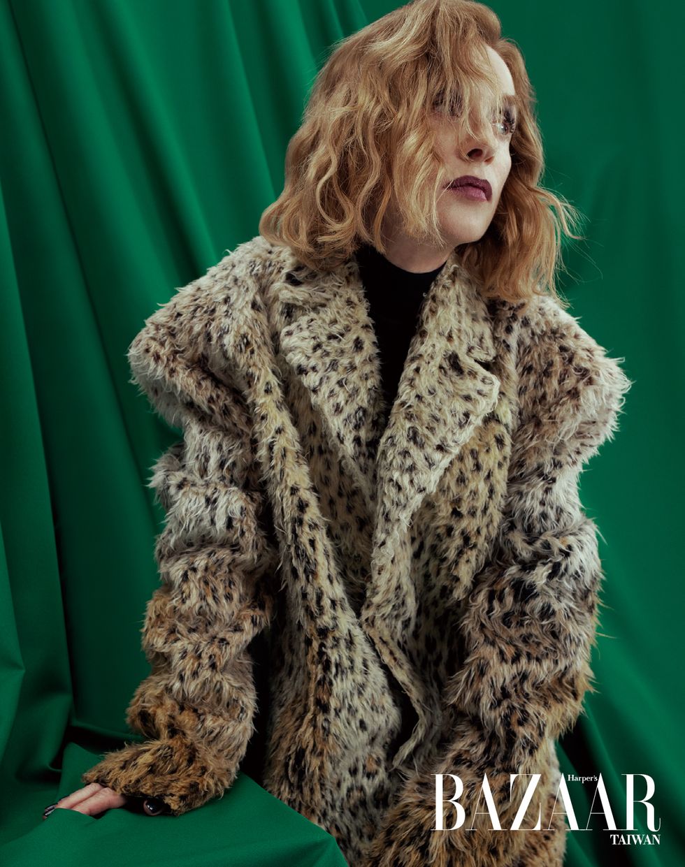 a woman wearing a fur coat