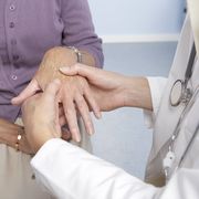 rheumatoid arthritis, general practitioner examining patient and hand for signs of rheumatoid arthri