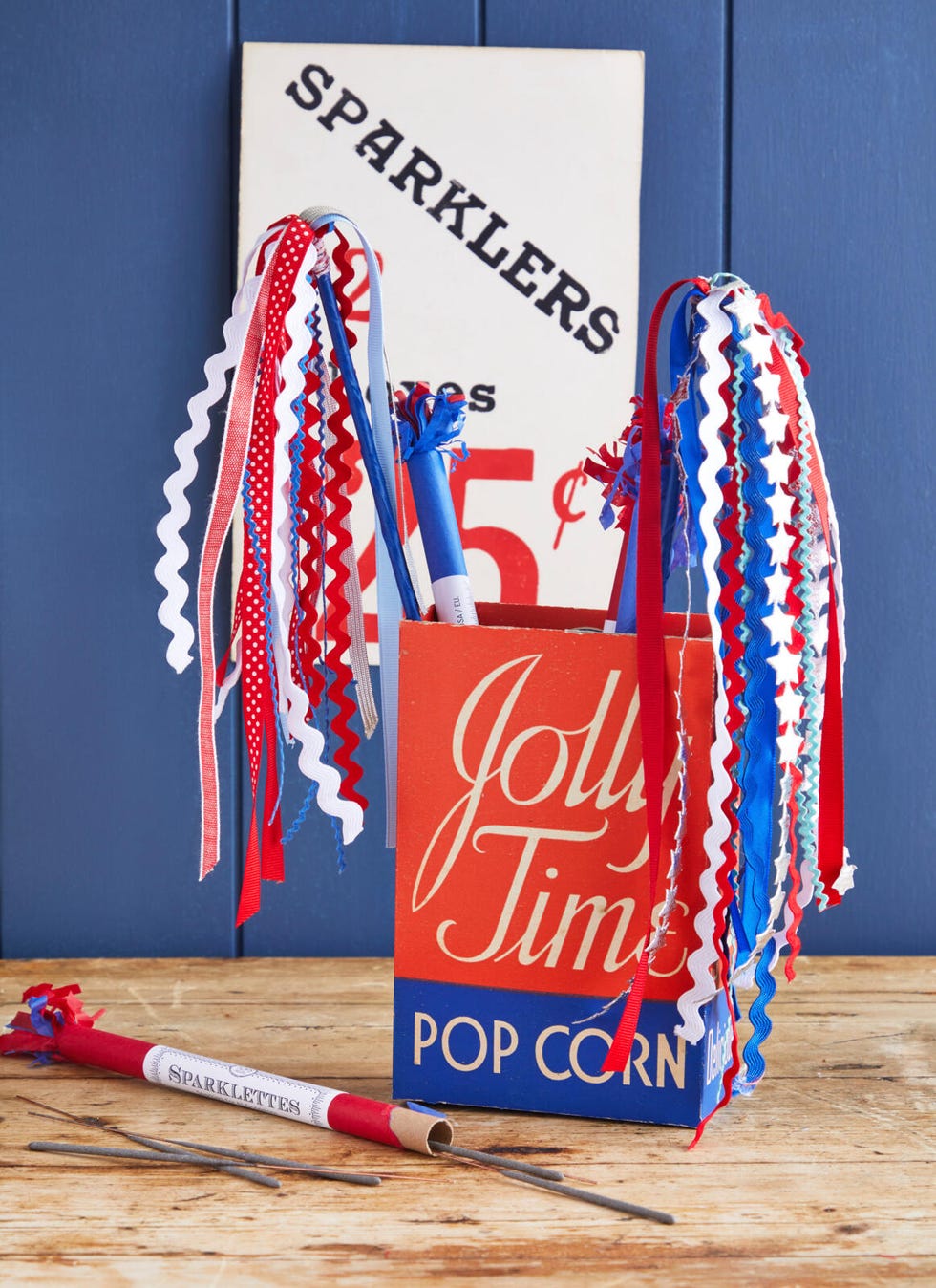 Fireworks made from ribbons and rickrack in an empty vintage Jolly Time popcorn box