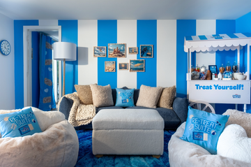 a blue and white room with a couch and bean bag chairs