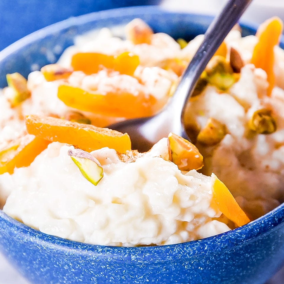 Rice Pudding bowl of creamy dessert topped with dried fruit and nuts