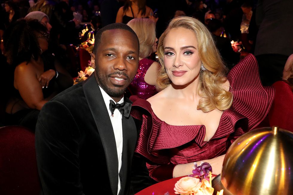 rich paul sitting to the left of adele at a round table and the two looking at a camera for a photo at an award show