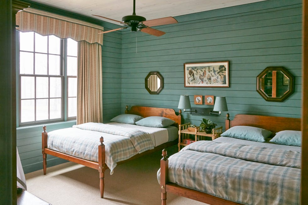 bedroom with two beds and green walls