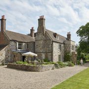 the sussex sandstone farmhouse dates to the 17th century, with porches and casement windows added around 1805