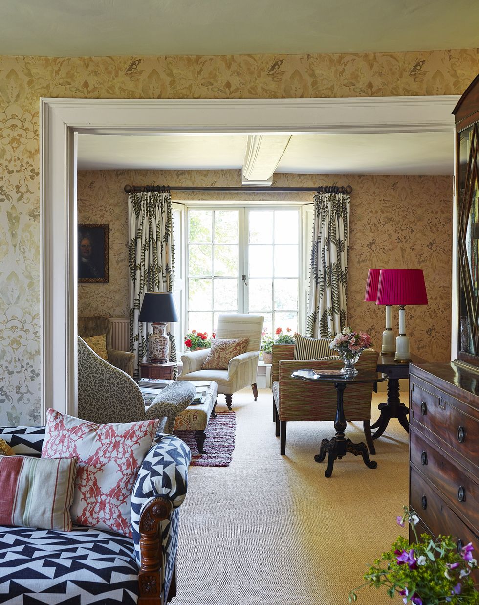 two separate rooms are connected by using the same wall covering and fabrics