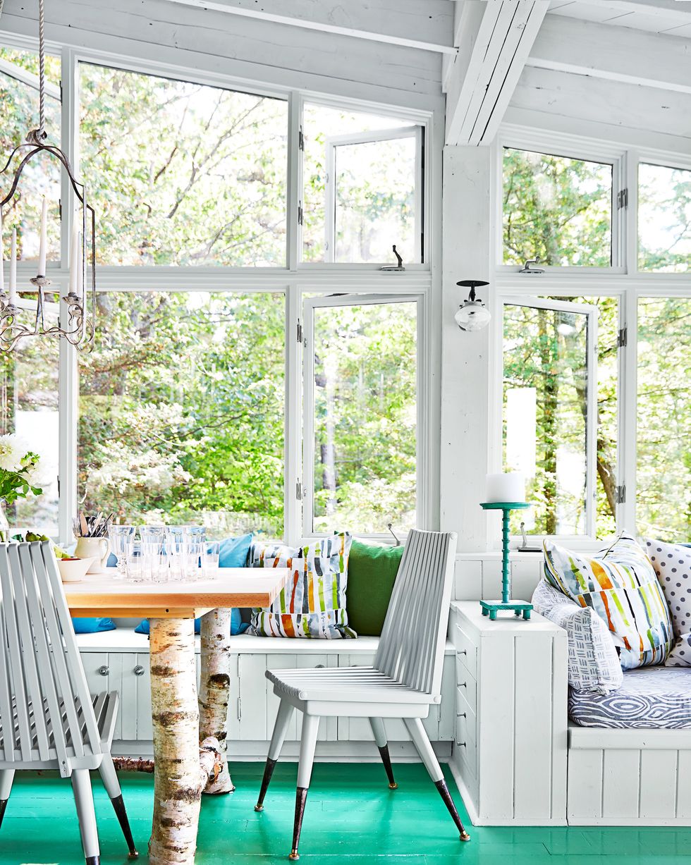 a sunroom with a table and chairs