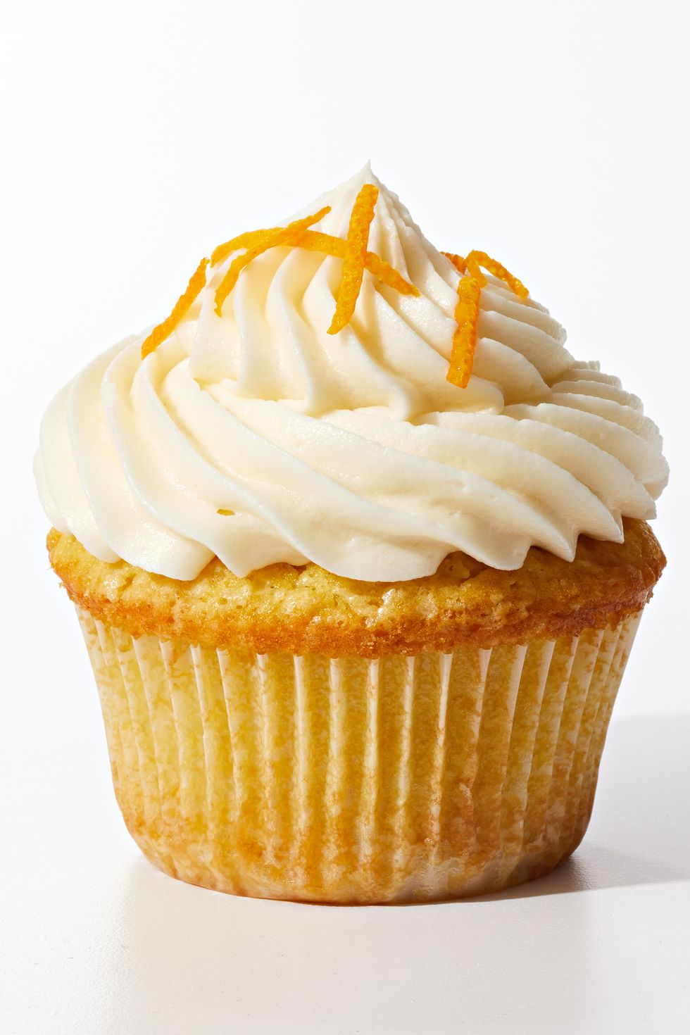 ricotta orange cupcake with buttercream frosting and citrus shavings on top