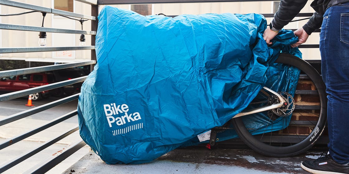 a person covering a bicycle