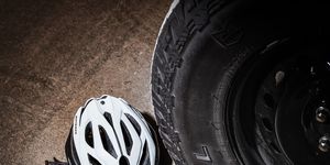 bicycling helmet in front of large truck tire