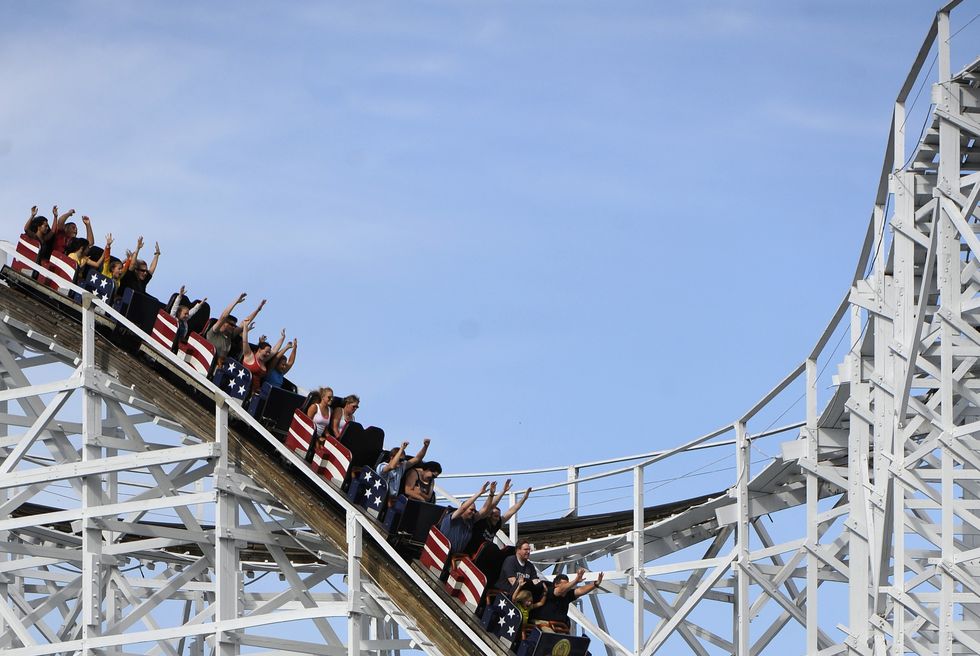 riders raise their hands as they sail down the first hill on the twister ii at elitch gardens in denver on monday, august 16, 2010 cyrus mccrimmon, the denver post