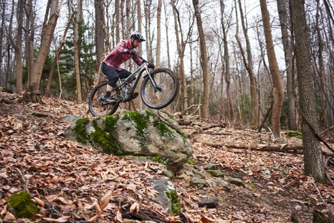 riding a drop on a mountain bike