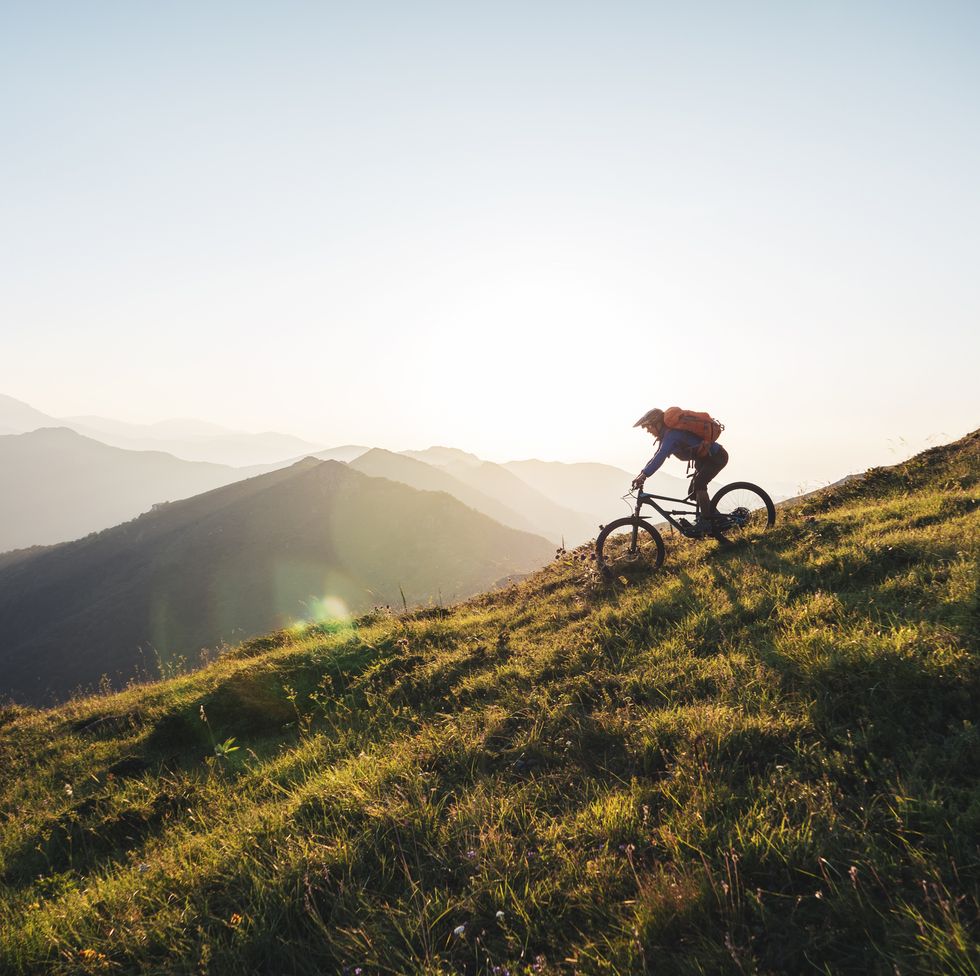 riding downhill in the mountains at sunset