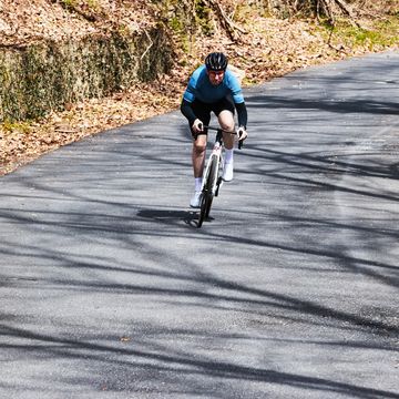 a person riding a bike down a road fast