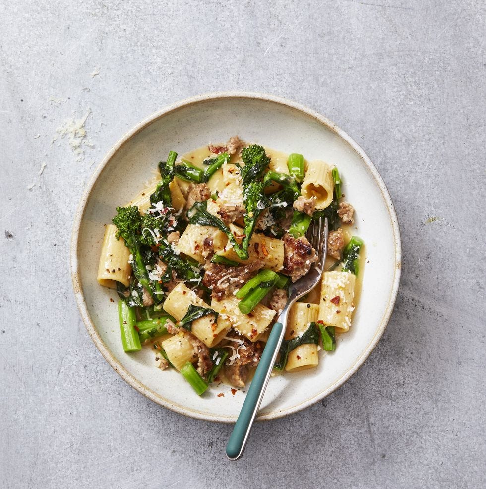 rigatoni with sausage and broccoli rabe in a white bowl