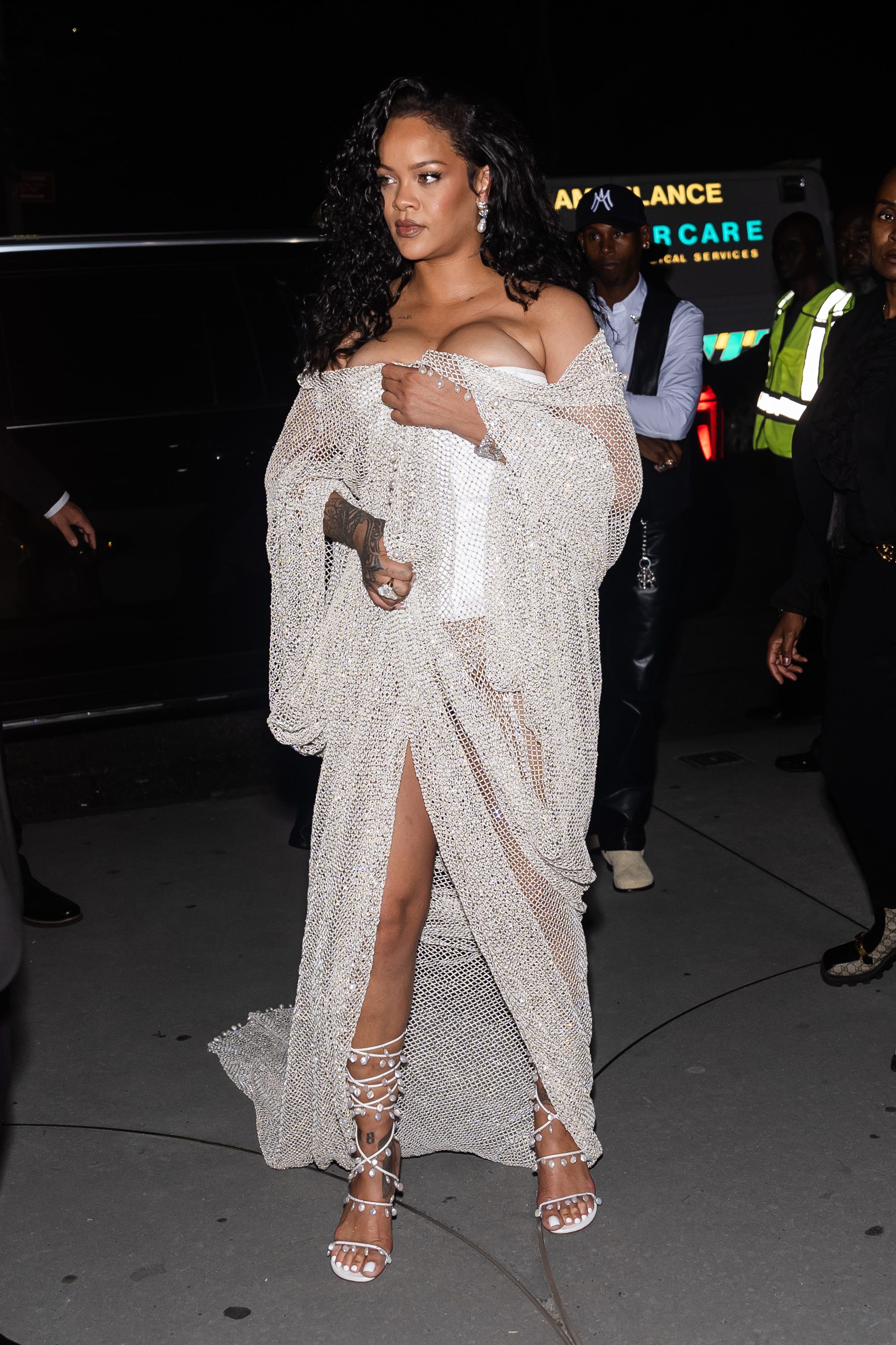 Rihanna Wears Shimmering Mesh Coat Over White Bustier to Alaia s Show