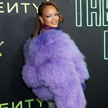 rihanna on red carpet in purple fur, for a fenty puma trainer launch