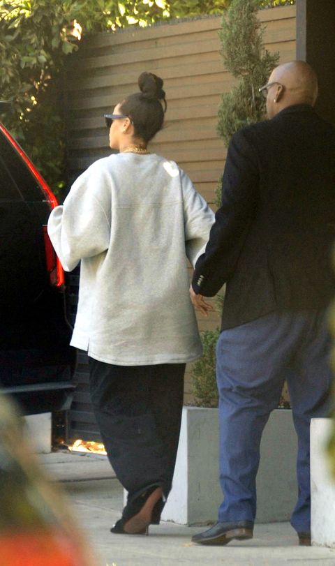 rihanna wears a large grey shirt and black pants after giving birth to a baby boy