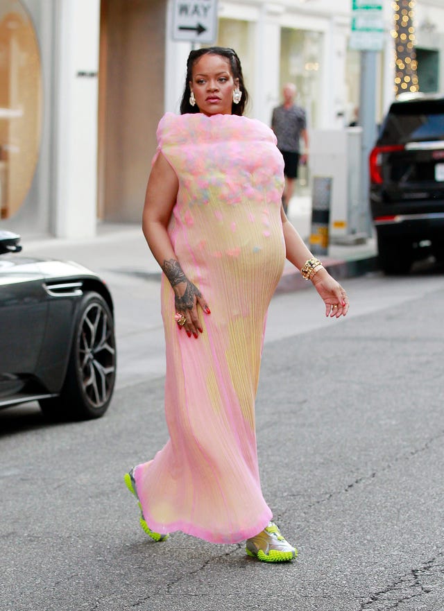 rihanna walking in a vibrant colorful outfit