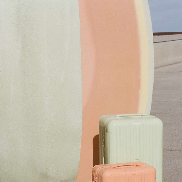 a couple of suitcases sit next to a pillar