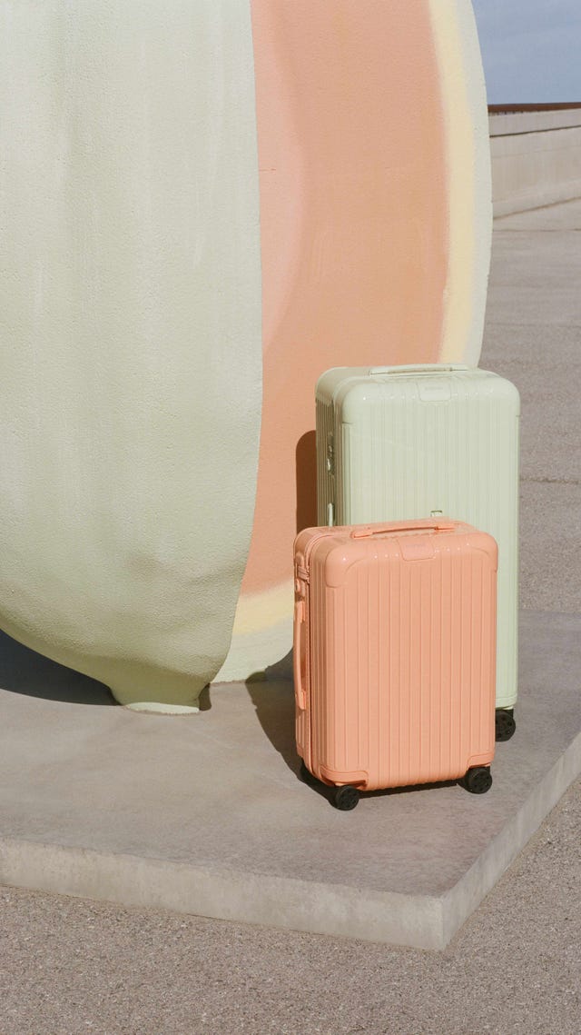 a couple of suitcases sit next to a pillar