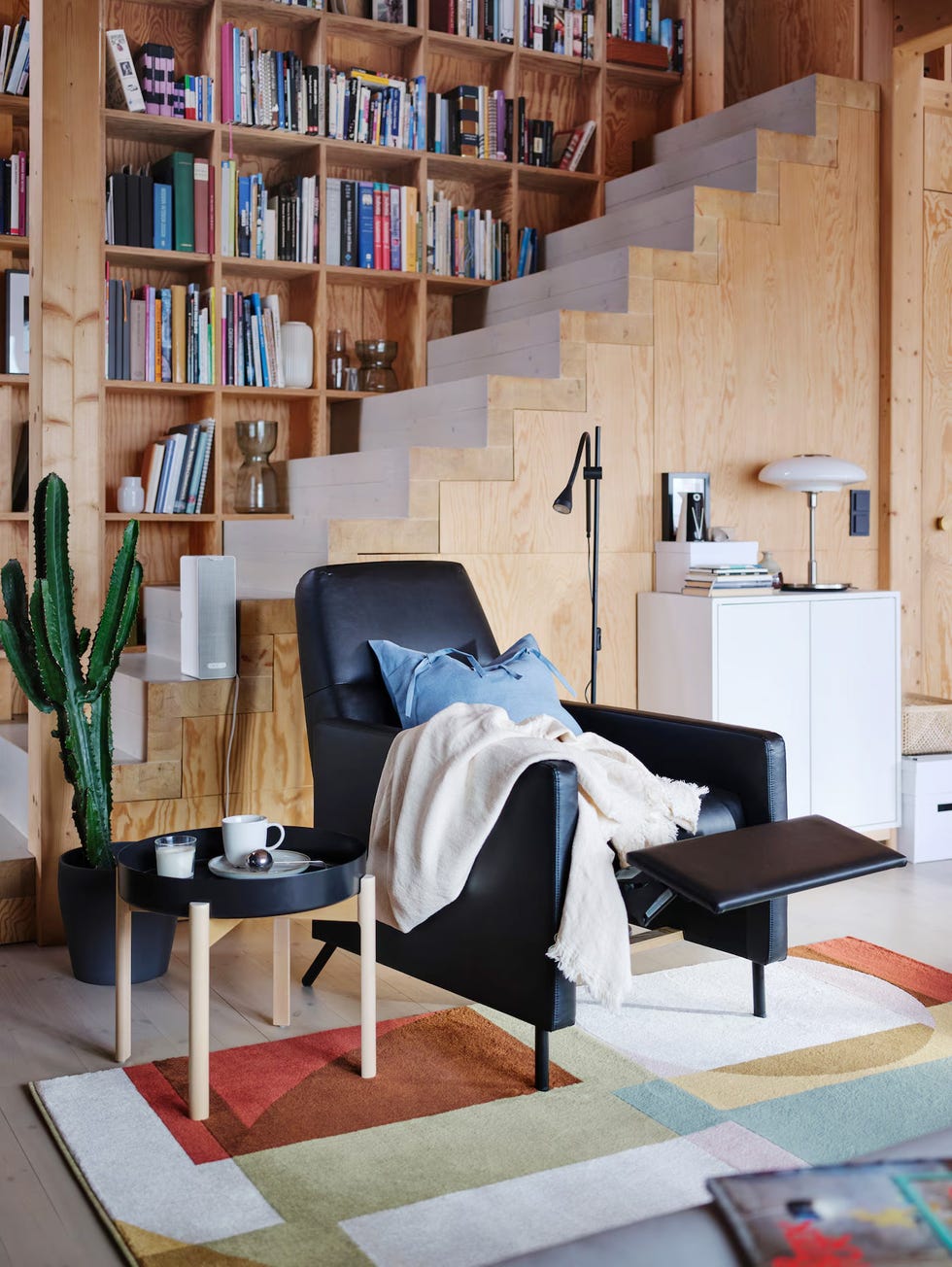 a room with a bookcase and a chair