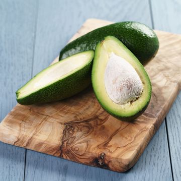 ripe avocado half cut on cutting board
