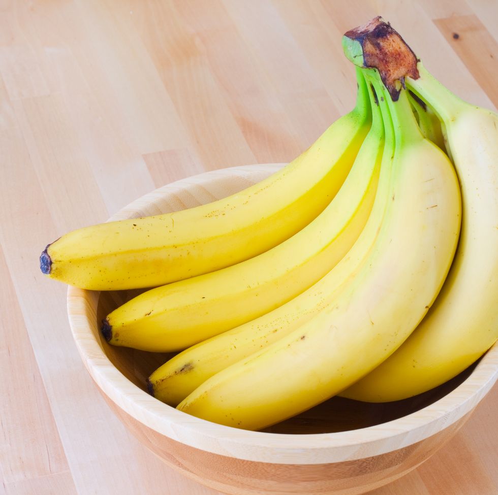 Ripe bananas in a wooden bowl