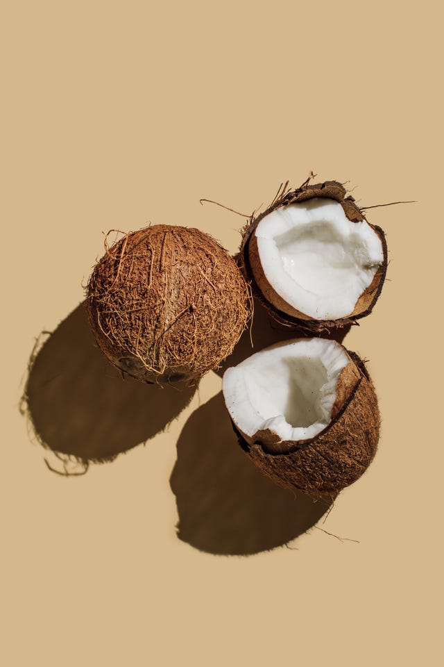 ripe coconuts on beige background creative summer concept half of coconut in minimal flat lay style top view, copy space