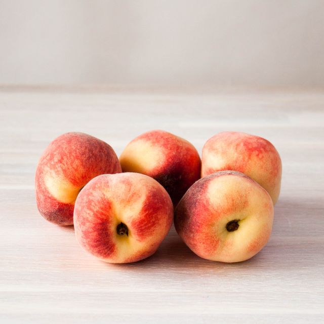 ripe fresh peach fruits whole on white