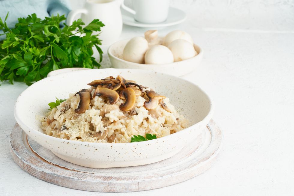risotto with mushrooms in plate rice porridge with mushrooms and parsley,romania