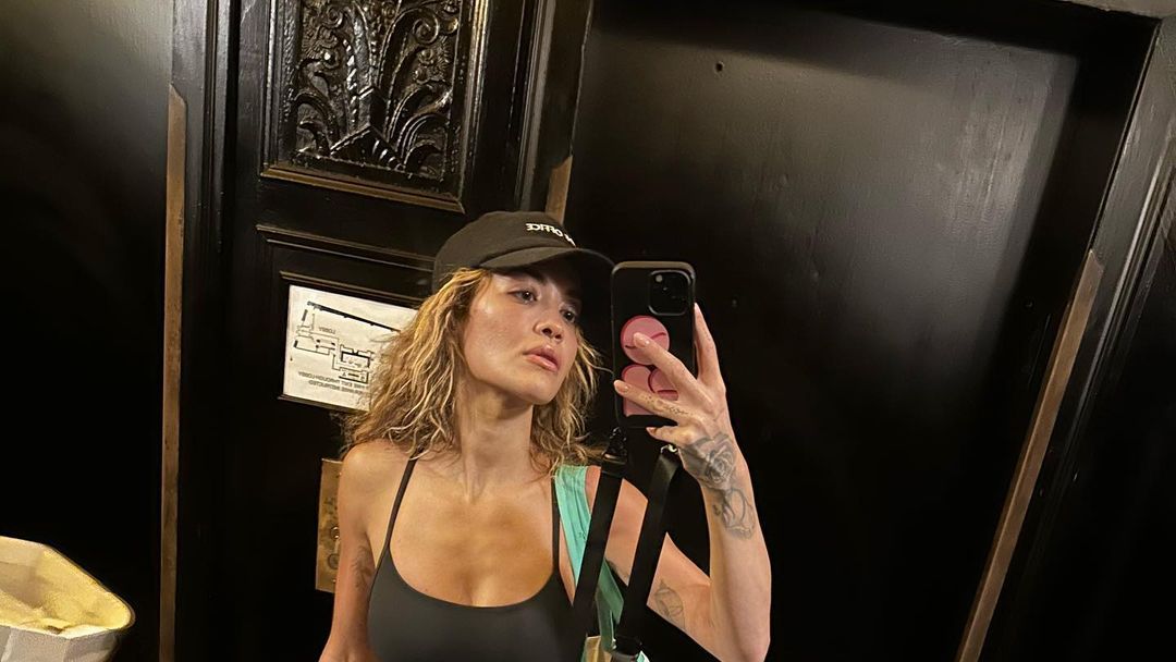 Rita Ora rocks a navy blue sports bra and leggings with Nike Dunks