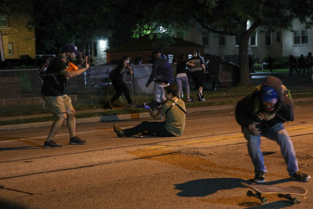 kenosha, wisconsin, usa   august 25 editors note image contains graphic content a man r was shot in the chest as clashes between protesters and armed civilians who protect the streets of kenosha against the arson during the third day of protests over the shooting of a black man jacob blake by police officer in wisconsin, united states on august 25, 2020 photo by tayfun coskunanadolu agency via getty images