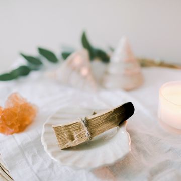 ritual objects for spiritual practice palo santo, candle and crystal